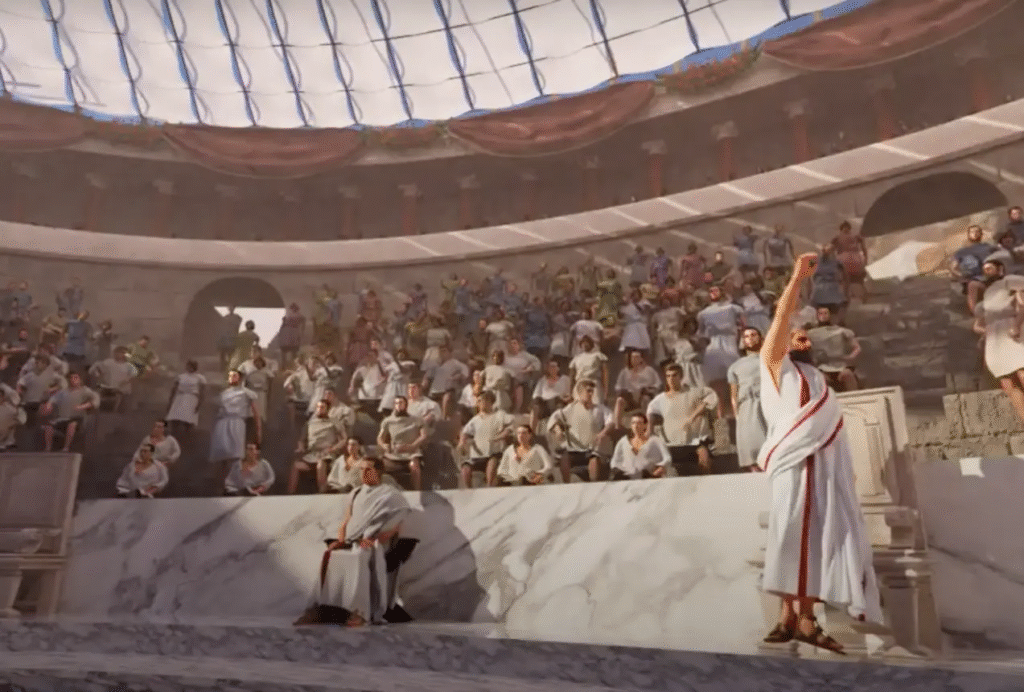 Render 3D del Teatro Romano de Málaga recreado en época romana, con público en las gradas y actores representando una escena sobre la orchestra.